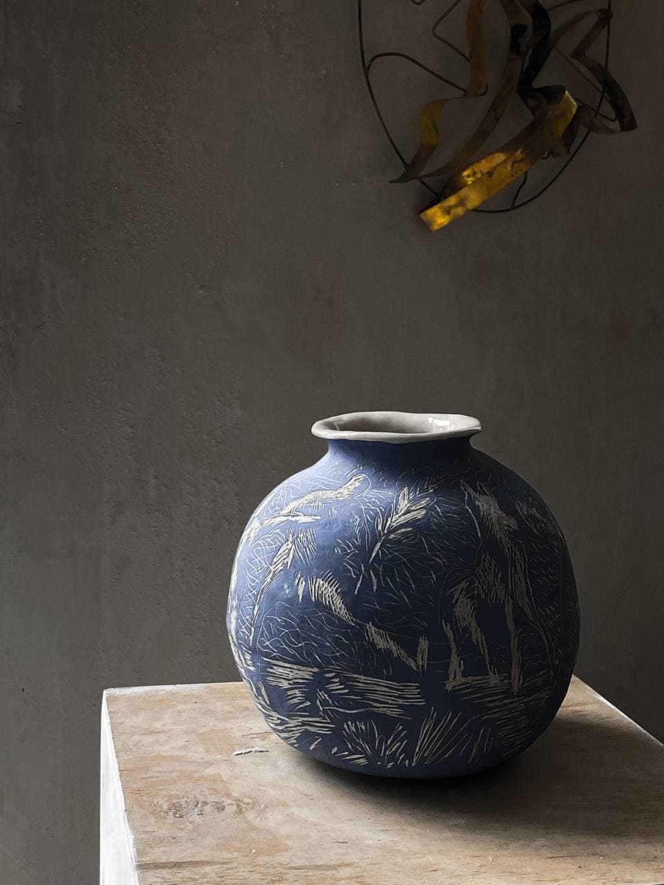 Blue ceramic vessel with graphic surface drawing