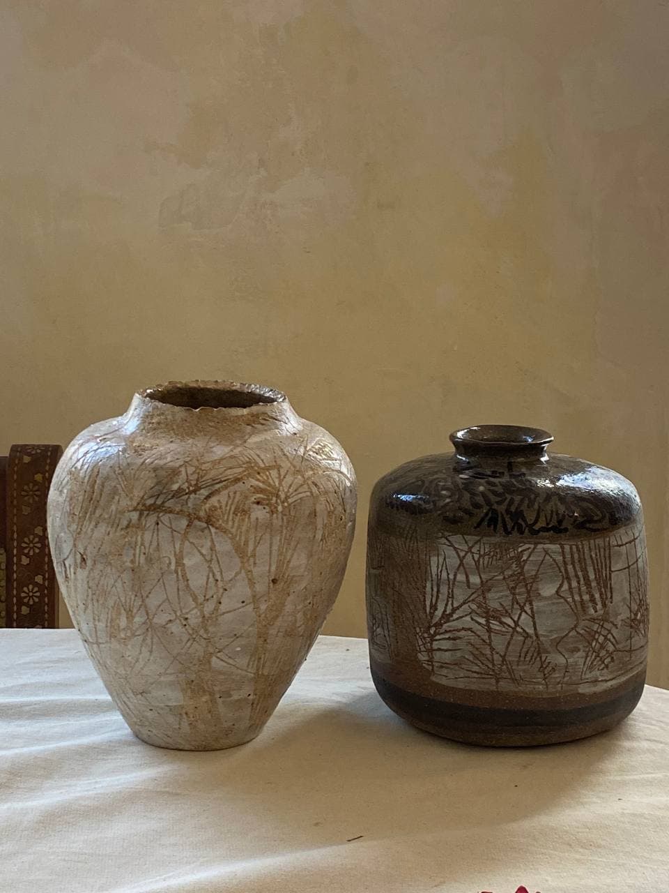 Pair of ceramic vessels with hand-drawn decoration